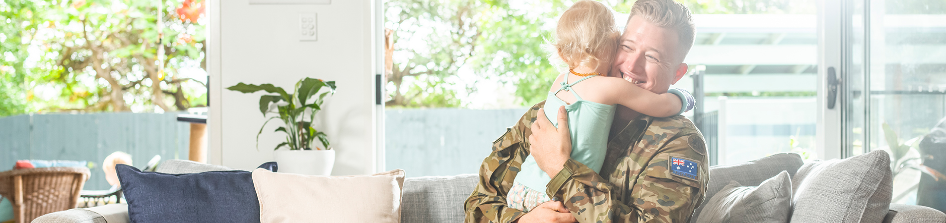 Young veteran hugging young daughter