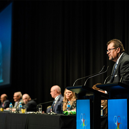 RSL Queensland AGM meeting Simon on podium