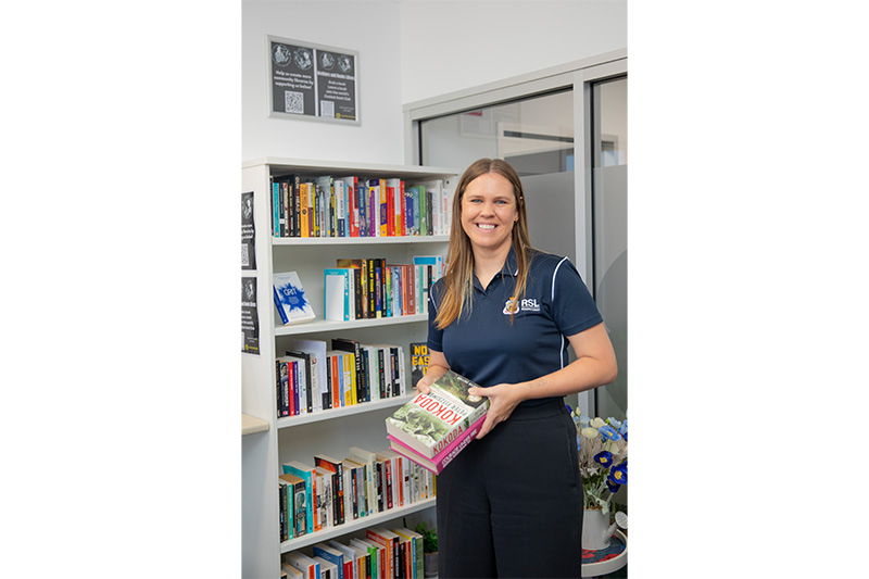 RSL staff holding books