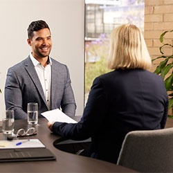 Man and woman sitting at a desk