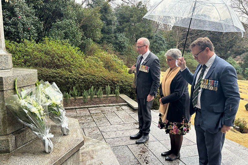 Major Trent Beilken lays a wreath at the Yokohama Cemetary