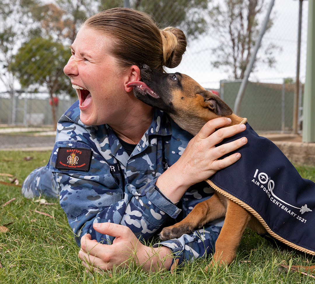 CPL Tegan Bowden with one of the puppies-in-training at RAAF Amberley