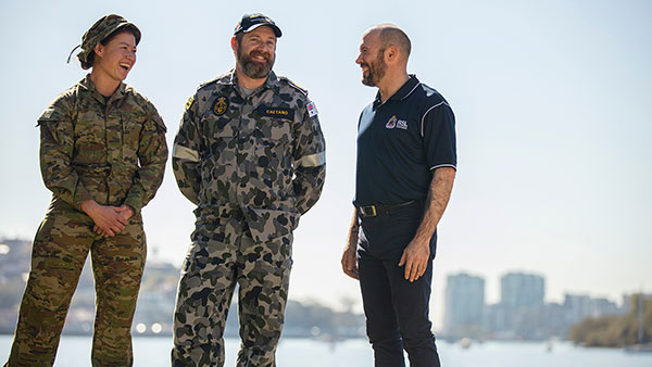 Two ADF members standing with an RSL Queensland representative