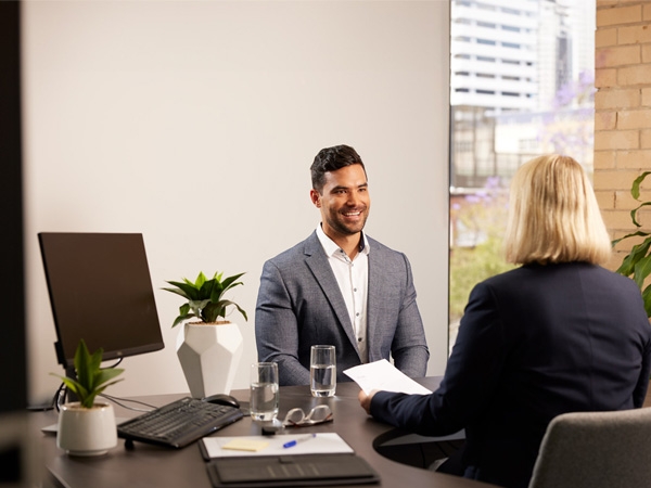 man sits across from woman in interview